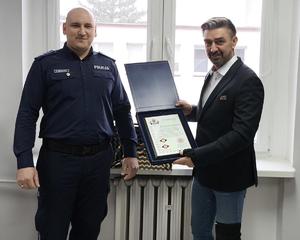 związkowiec przekazuje grawerunek emerytowanemu policjantowi